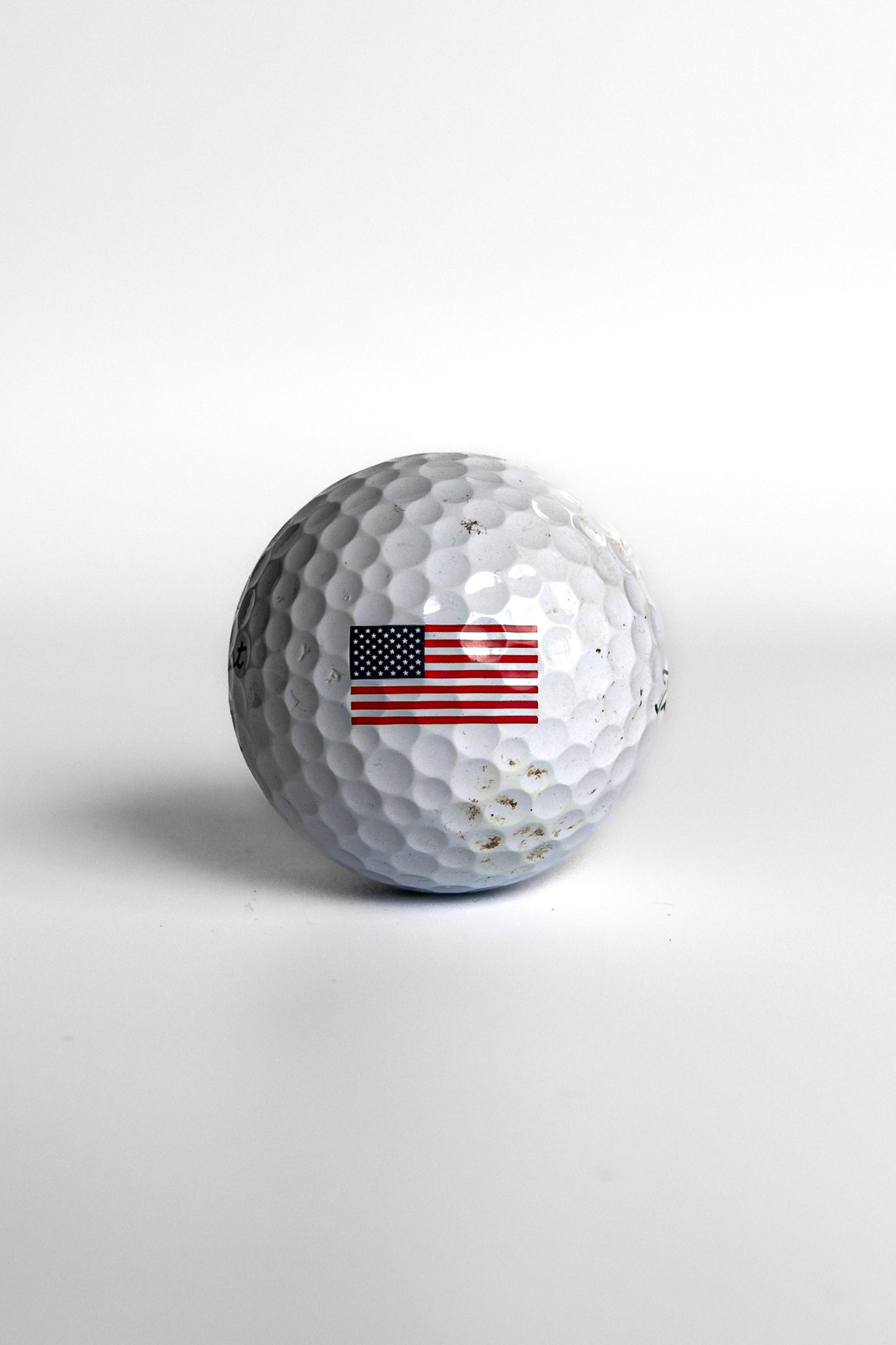 Titleist Pro V1 golf ball with American flag stars and stripes centered white background