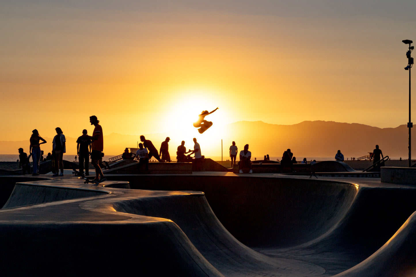 Venice Beach skatepark with concrete bowl at golden hour in Los Angeles California