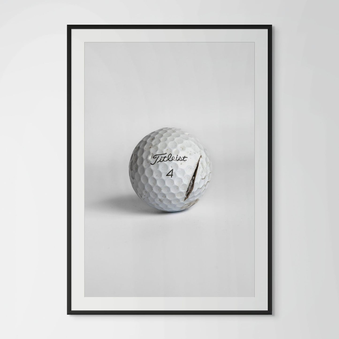 Titleist Pro V1 clean cracked golf ball framed photography print in black wood frame