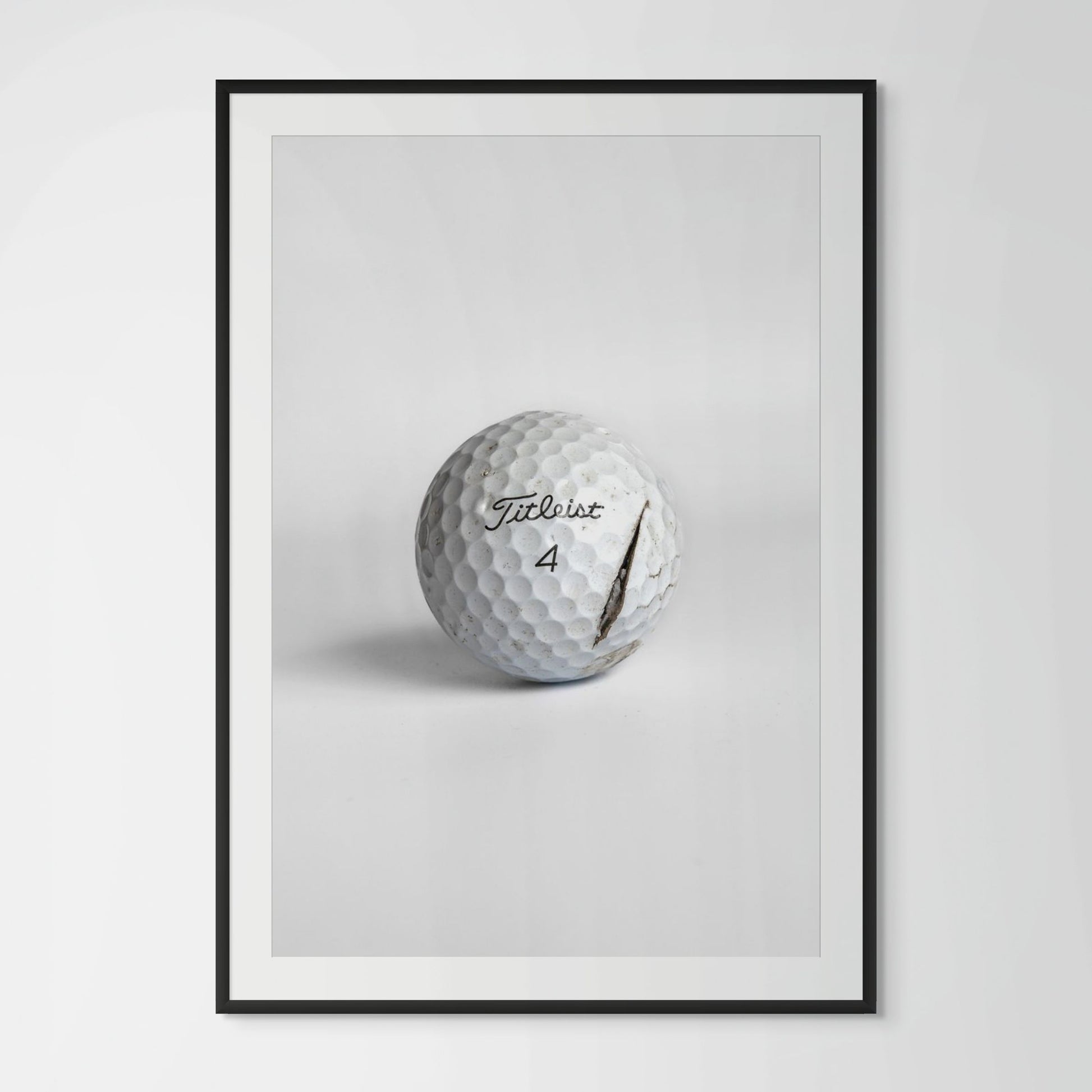 Titleist Pro V1 clean cracked golf ball framed photography print in black wood frame