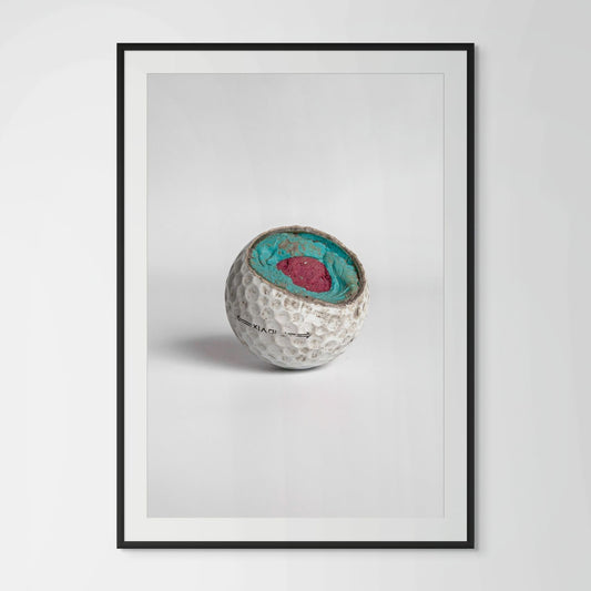 Titleist Pro V1 exposed turquoise pink core golf ball framed photography print in black wood frame