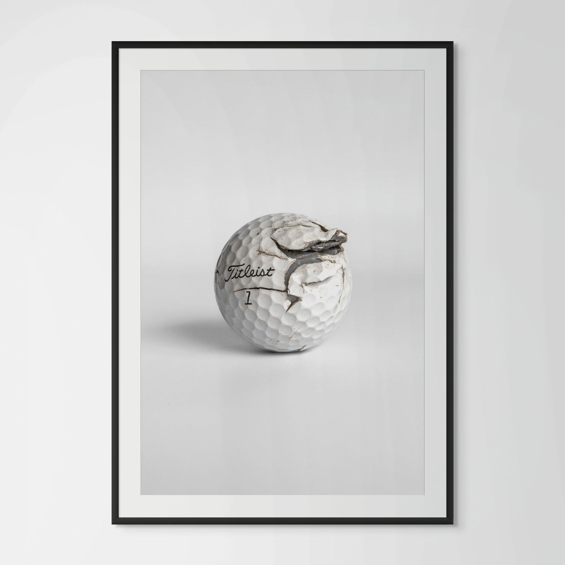 Titleist Pro V1 fractured golf ball framed photography print in black wood frame