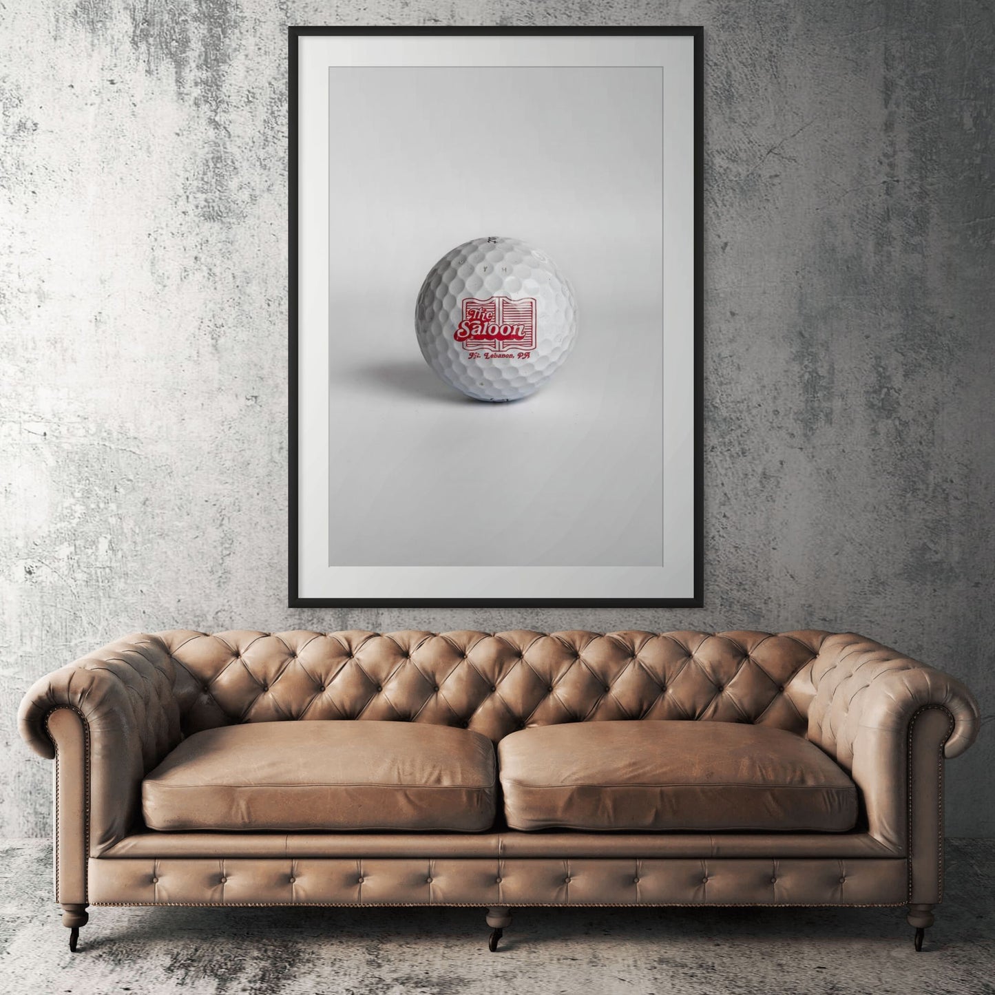Titleist Pro V1 The Saloon Mt. Lebanon PA golf ball framed print displayed above tan leather sofa in living room