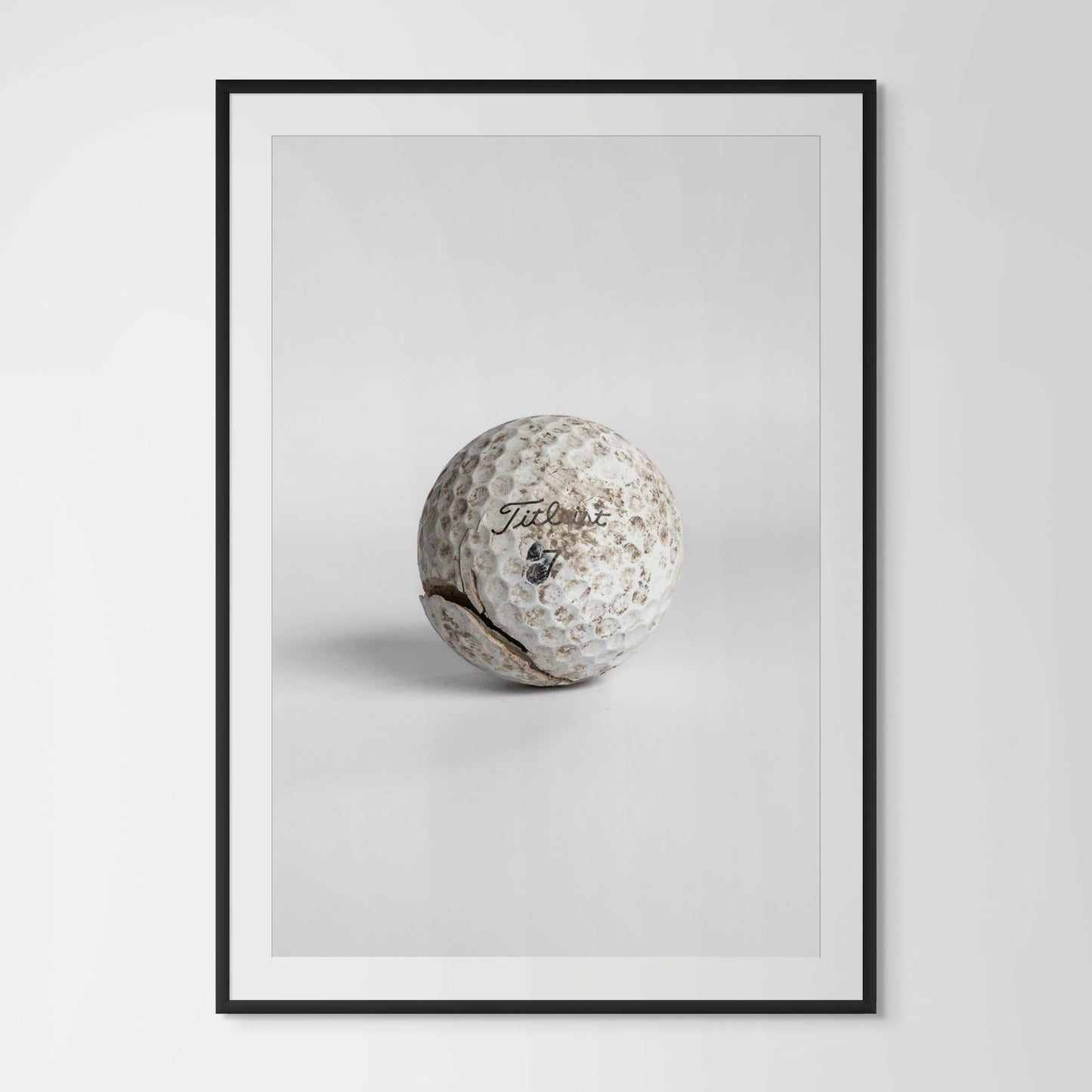 Titleist Pro V1 worn dirty golf ball framed photography print in black wood frame