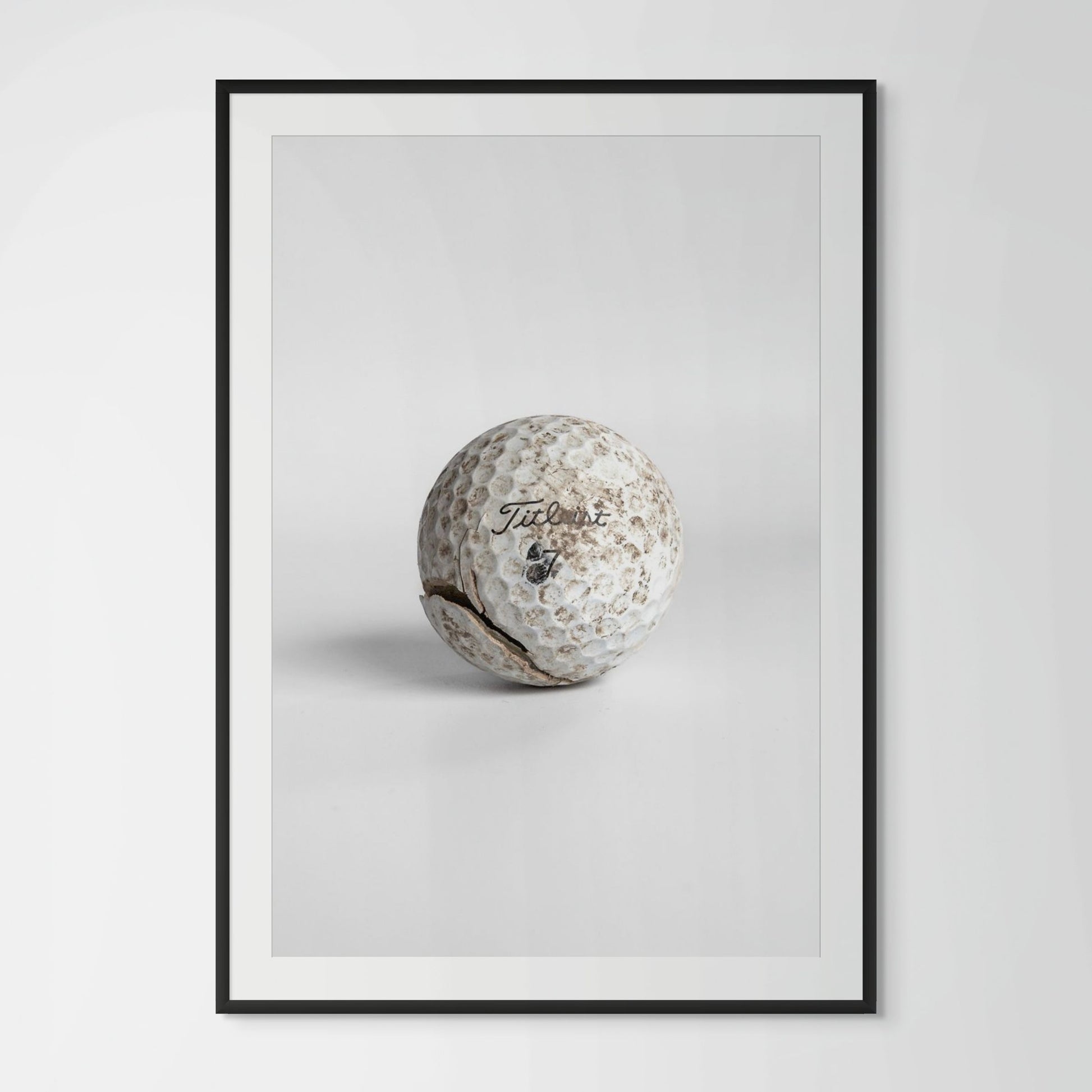 Titleist Pro V1 worn dirty golf ball framed photography print in black wood frame