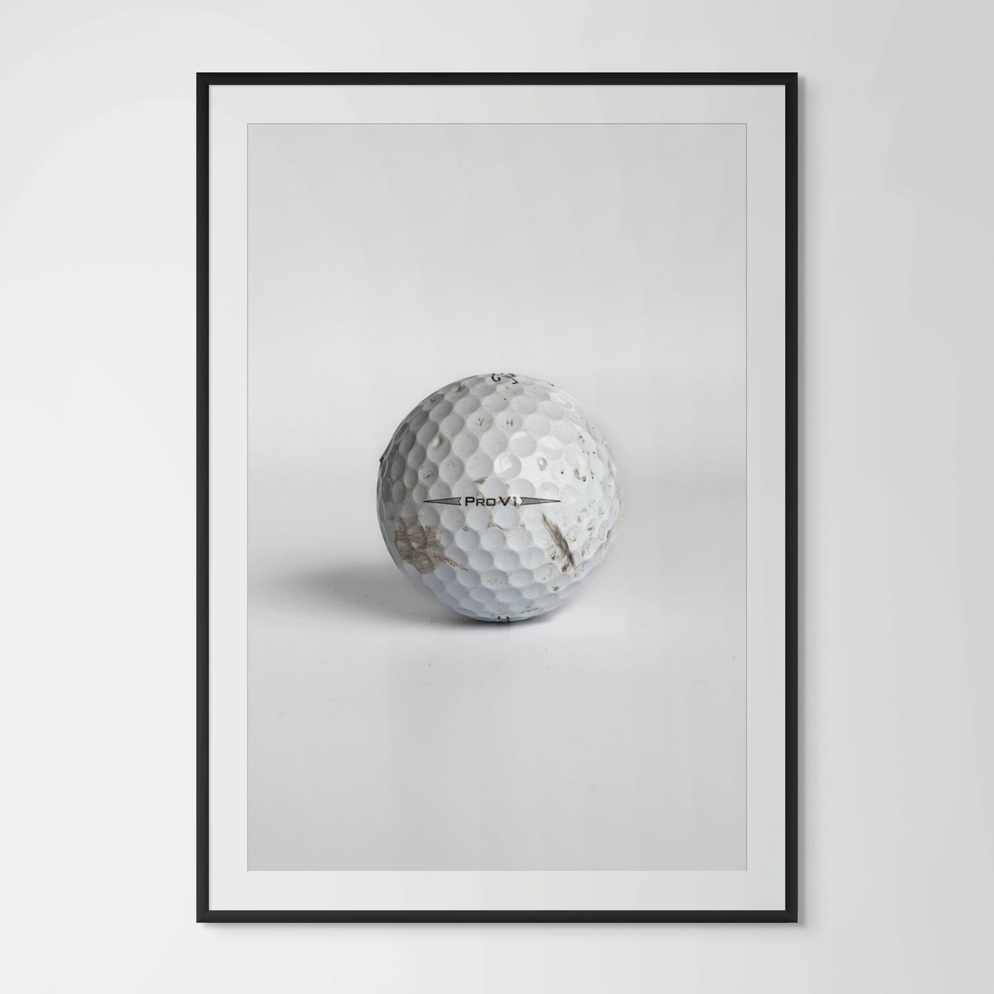 Titleist Pro V1 scuffed golf ball framed photography print in black wood frame