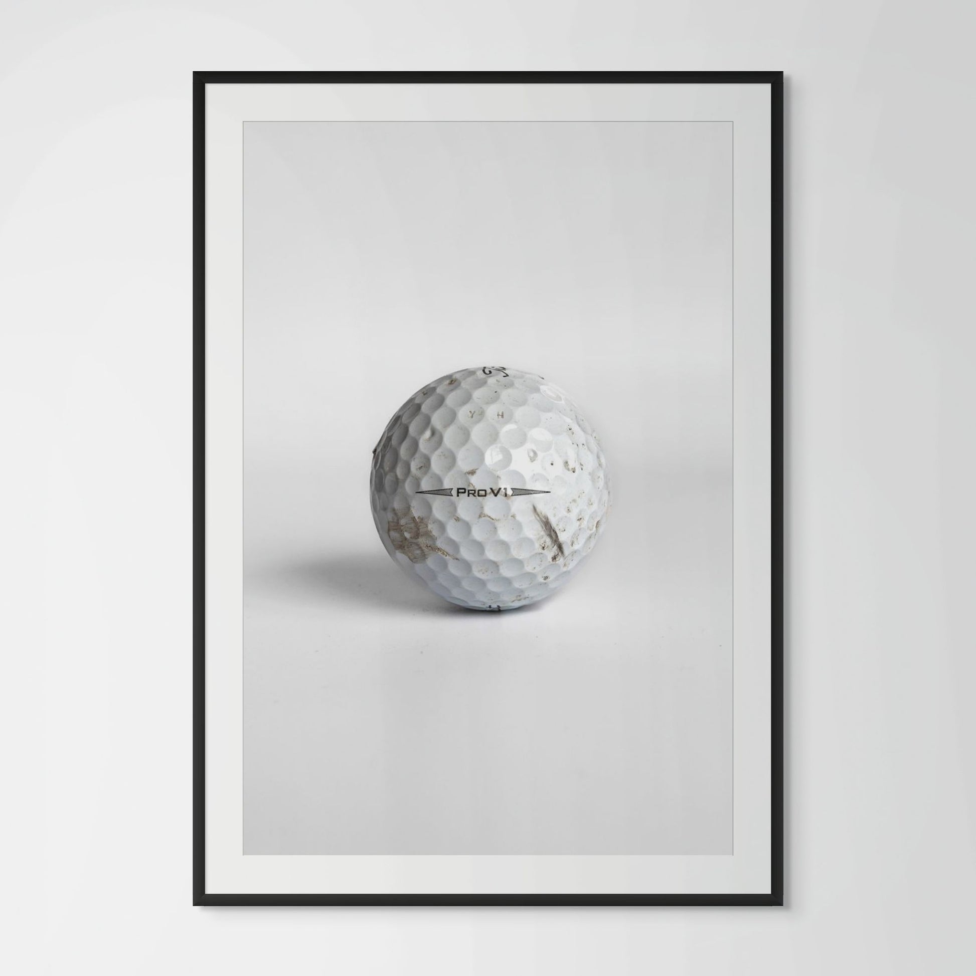 Titleist Pro V1 scuffed golf ball framed photography print in black wood frame