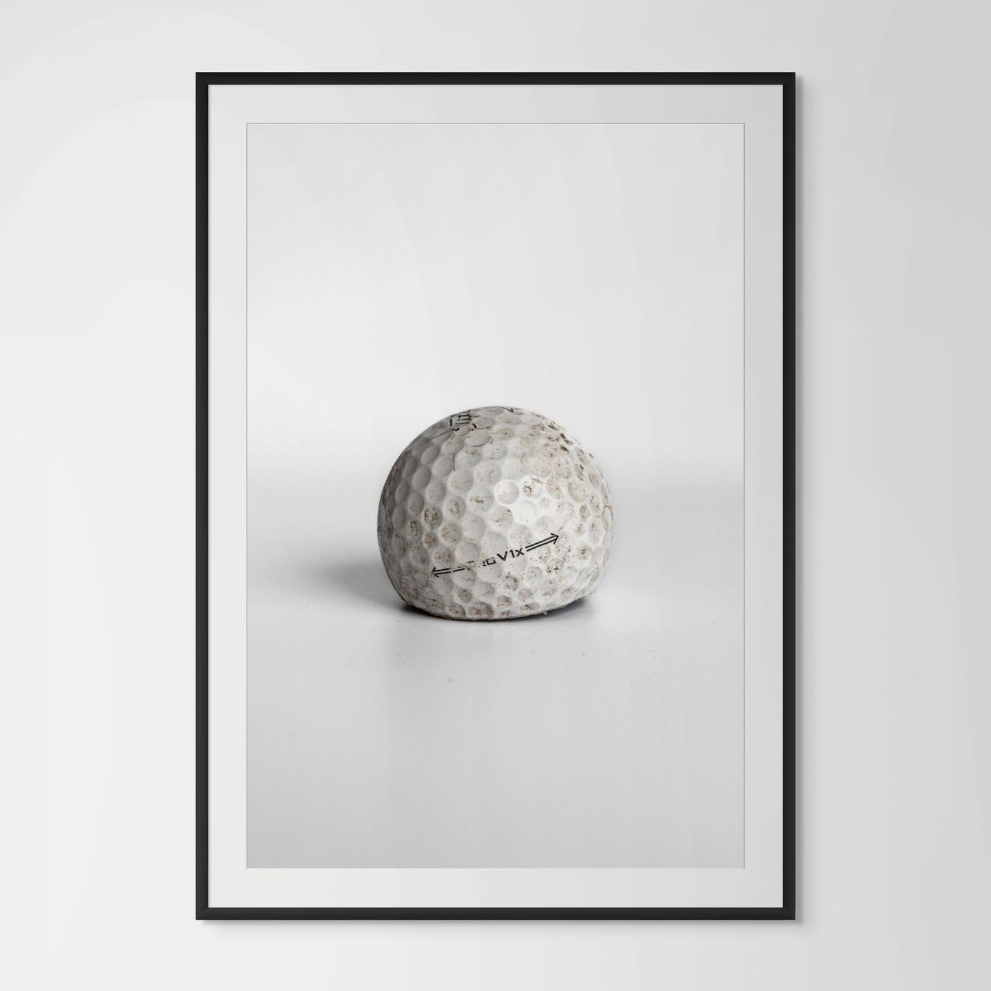 Titleist Pro V1x aged dirty golf ball framed photography print in black wood frame