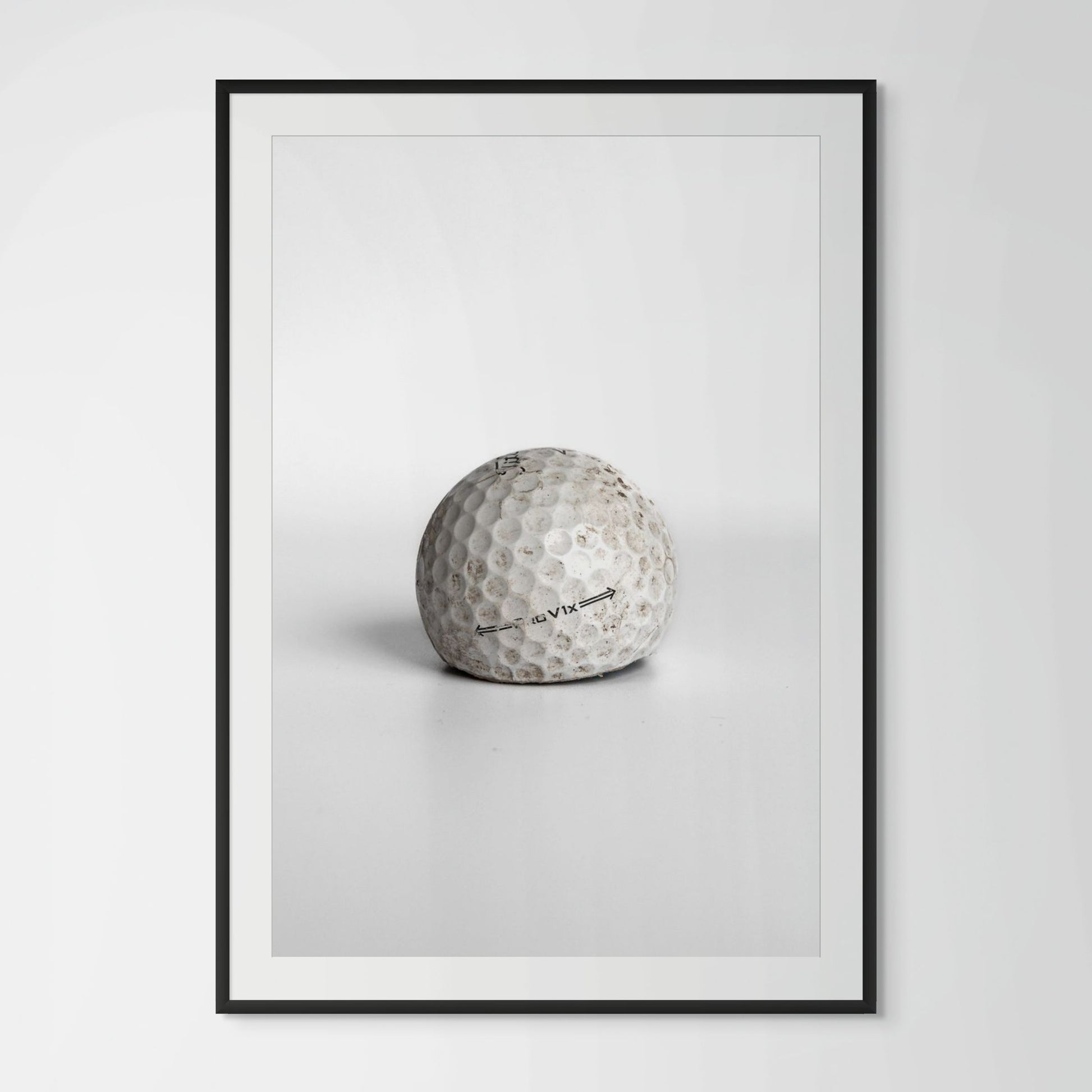 Titleist Pro V1x aged dirty golf ball framed photography print in black wood frame