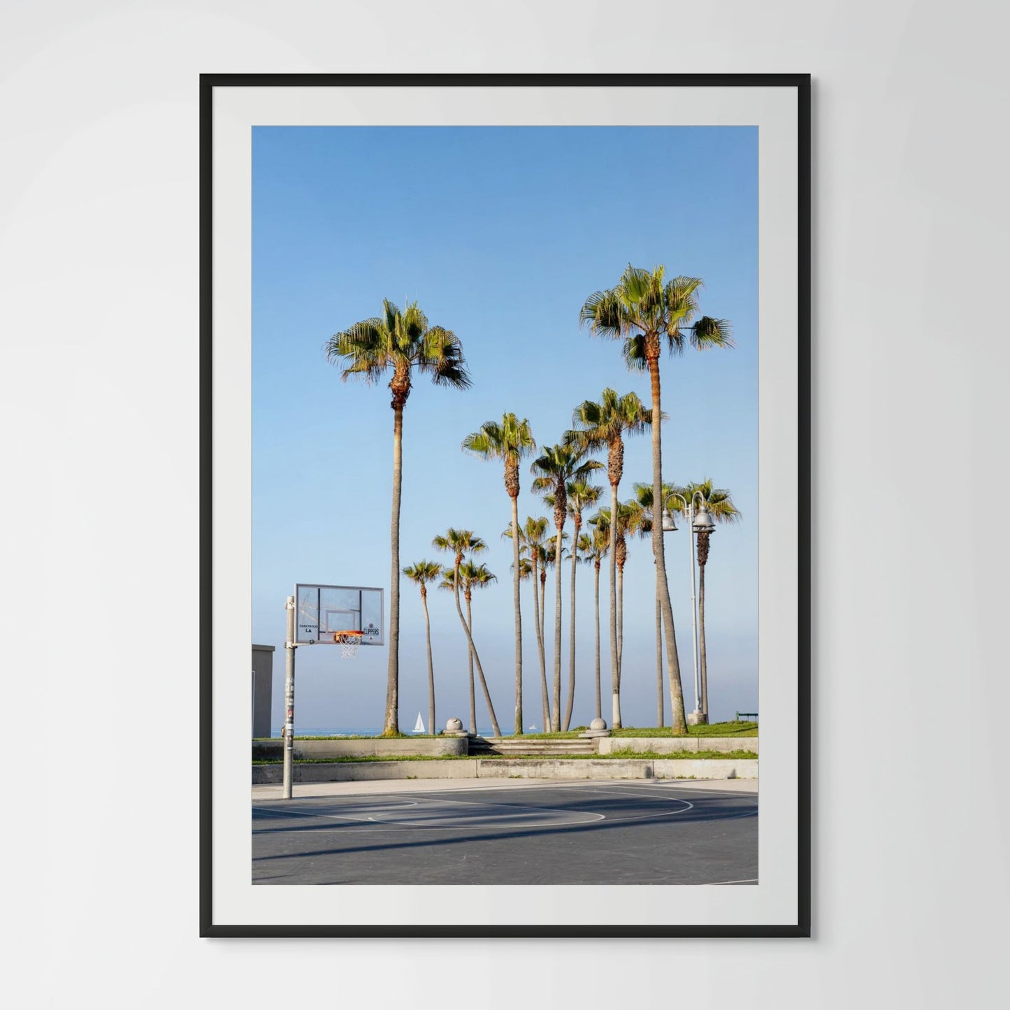 Venice Beach outdoor basketball courts with palm trees and ocean view at golden hour California