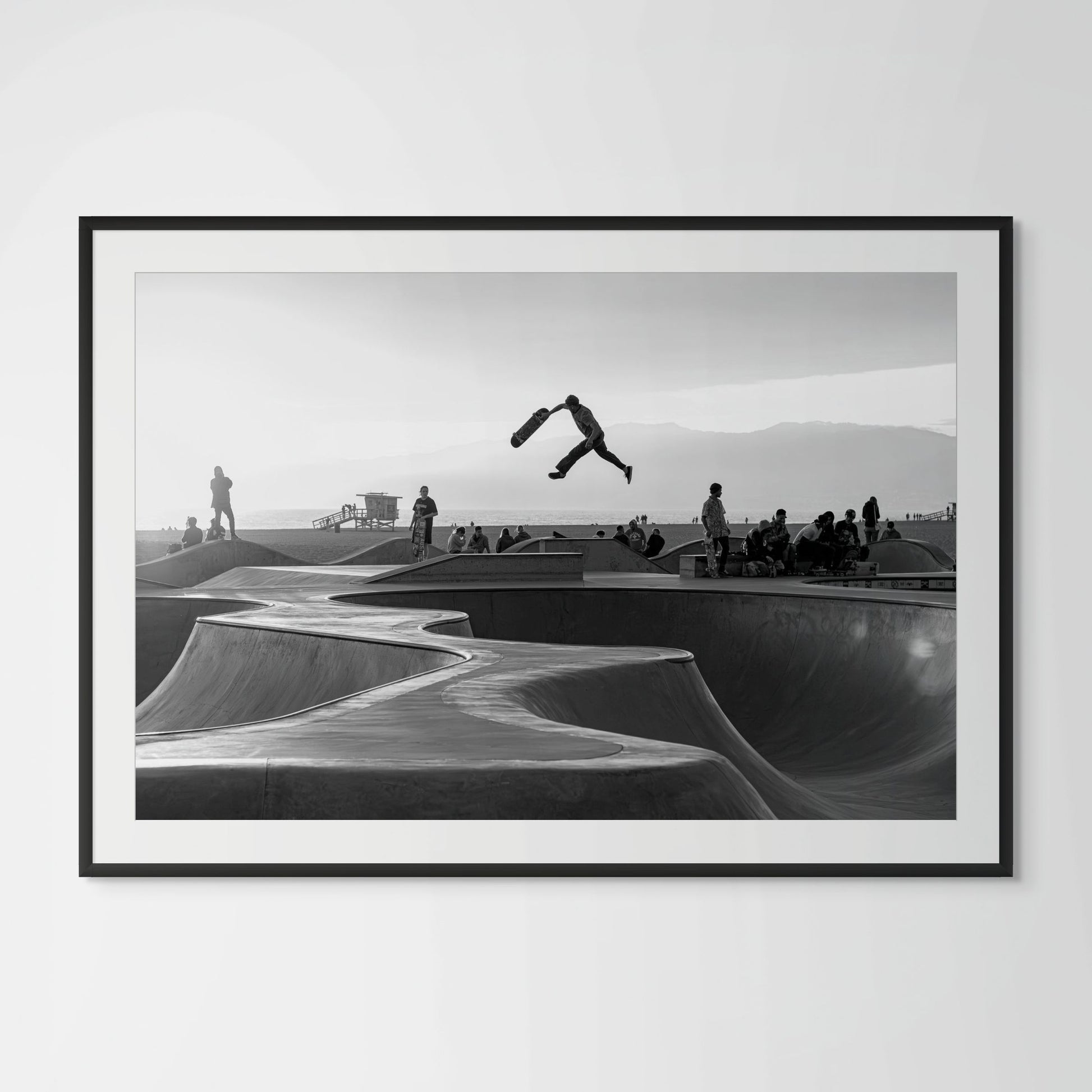 Venice Beach skatepark aerial trick black and white framed photography print in black wood frame