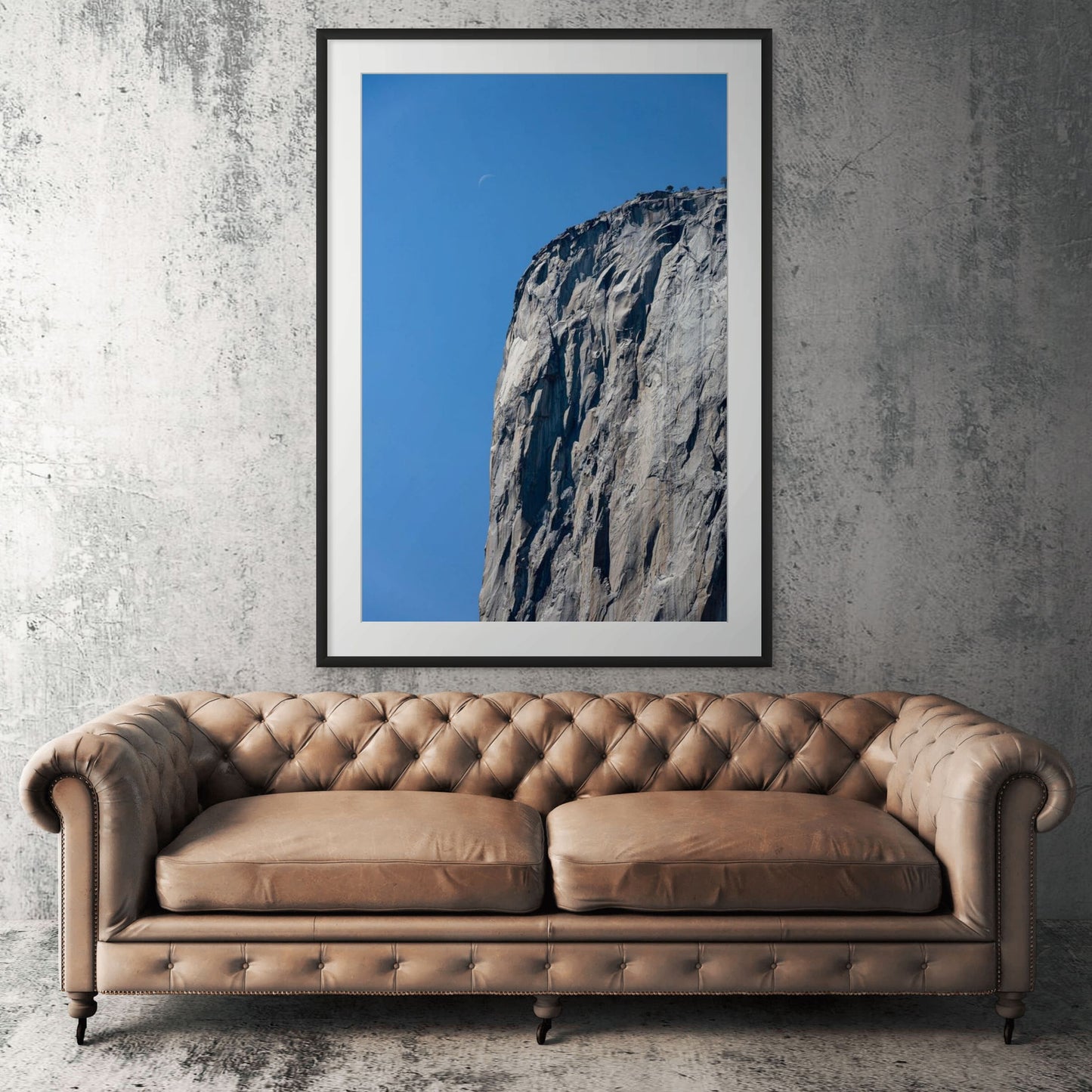 Yosemite El Capitan framed print displayed above tan leather sofa in living room